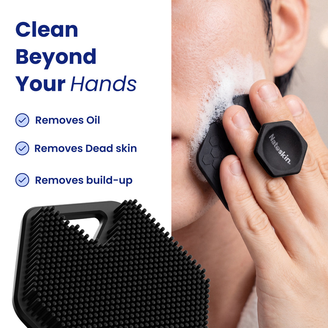 Black silicone facial cleansing brush with a hexagonal handle and bristled cleaning head, shown being used on a person's face with soap lather, alongside product text and a close-up of the brush head.
