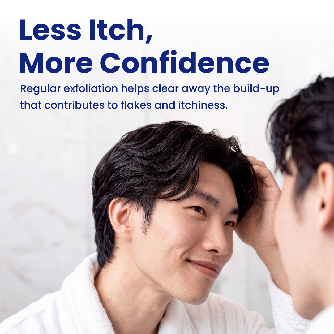 A man in a white robe looks at his reflection in a bathroom mirror while another hand gently touches his hair. Large blue text at the top reads, 'Less Itch, More Confidence' with smaller descriptive copy below.