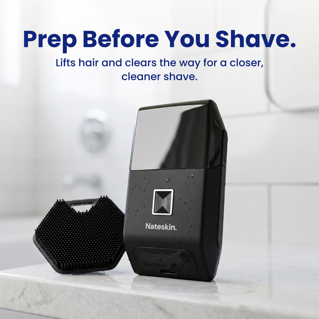 Nateskin electric shaver in black shown on a bathroom counter next to a black brush attachment, with promotional text at the top reading 'Prep Before You Shave.'.