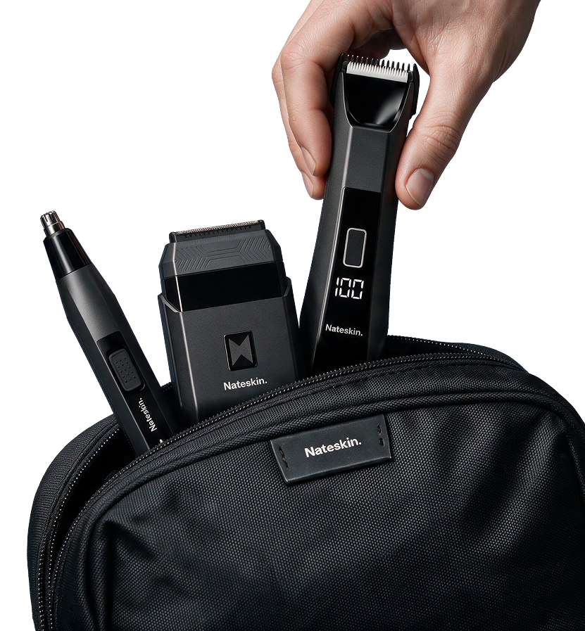 A hand holds a black Nateskin electric trimmer above a black zippered pouch containing other Nateskin grooming tools, shown on a clean white background.